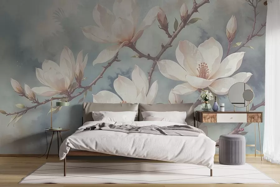 wall murals White magnolia flowers blooming on tree branches against a soft, blurred textured blue background w08383