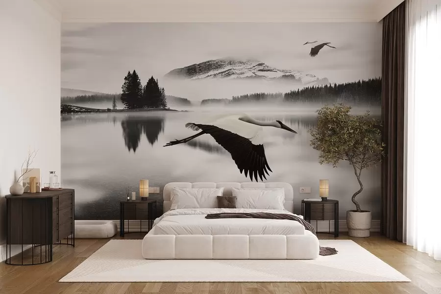 wall murals A stork in flight over a river and mountains, black-and-white landscape with birds w08658